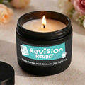 Candle in a jar with 'Revision Regret' label on a neutral background