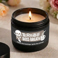 Candle in a container labeled 'Terrible Boss Breath' with a skull and coffee cup design.